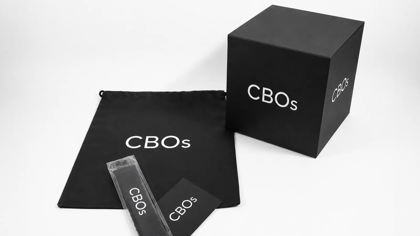Custom packaging set with black CBOs box, drawstring bag, tag, and wrapped strap